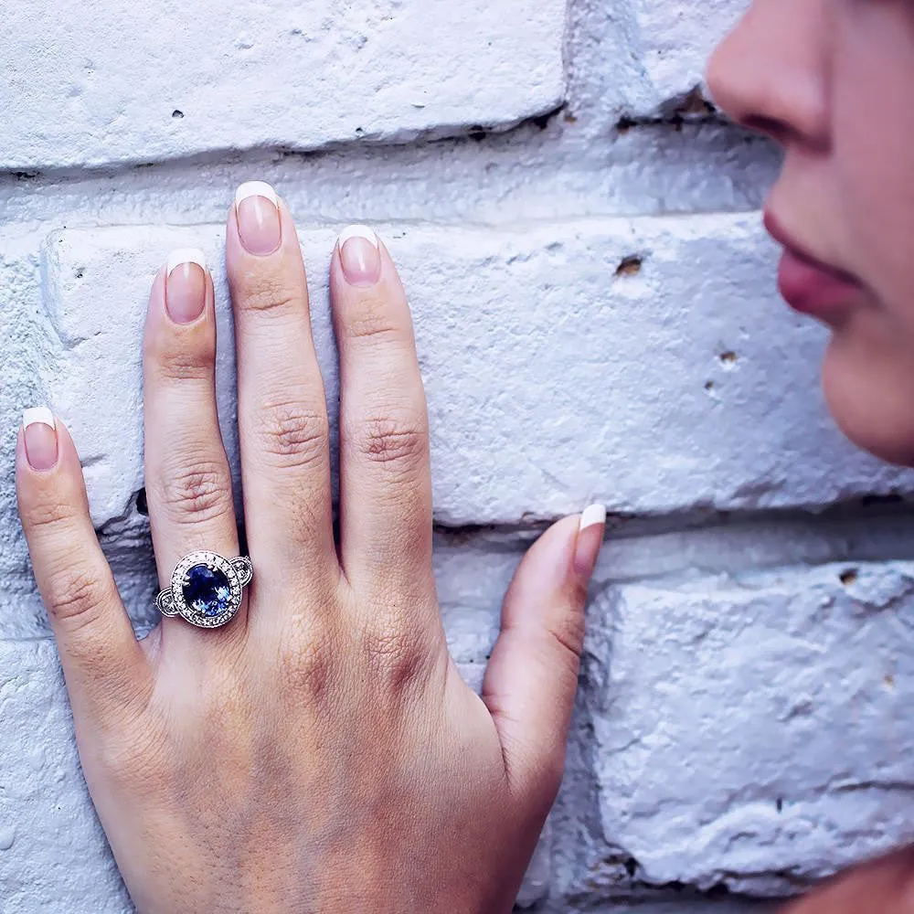 Oval Tanzanite Halo Ring with Half Moon Diamond’s 18K